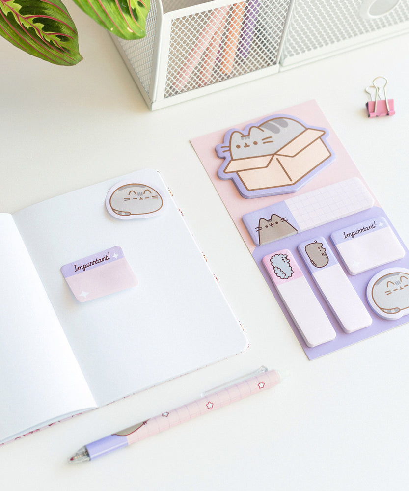 Notebook and included sticky note tabs in the Pusheen Deluxe Stationery Set. The purple and pink tabs include various Pusheen graphics as well as Stormy.