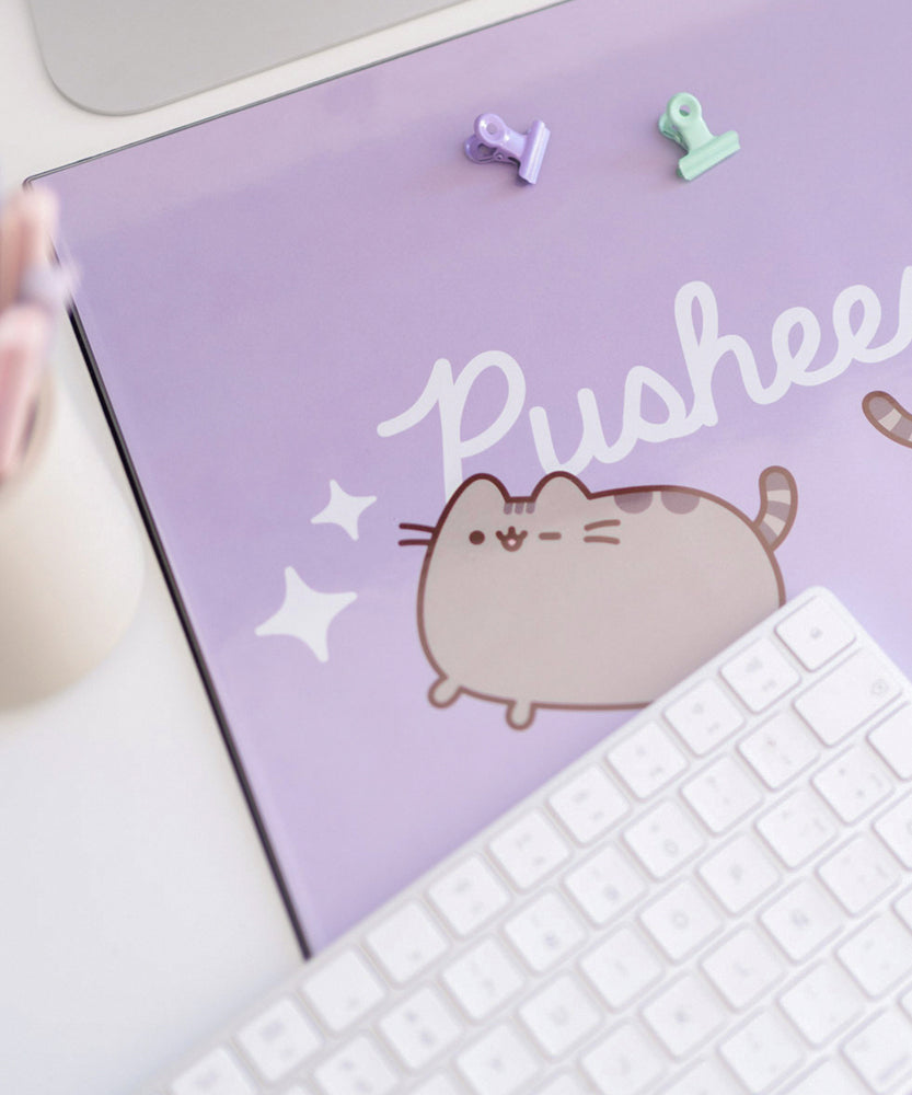 Close-up of the slightly reflective plastic material that encases the Pusheen design on the desk mat. 