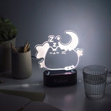 Front view of the dreams Pusheen lamp lit up. The clear acrylic cat body emits a white hue when turned on.  