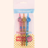 Pusheen Fruits 3-Pen Set in its resealable packaging bag. The pink and clear bag includes graphics of Pusheen Strawberry, yellow checkered print, and the phrase "100% Real Cute."