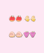 All earrings in Pusheen Fruits 4-Pack Stud Earrings Stud shown. From left to right and top to bottom, the stud earrings include Pusheen as fresh fruits including apples, bananas, peaches, and grapes. 