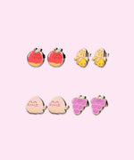 Pusheen Fruits 4-Pack Stud Earrings Set on their cardboard backing card. The top half of the card has the Pusheen logo in brown on a light pink background and the bottom half of the card is purple. 