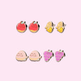 Earrings in the Stud Set turned to the side to show the shine of the outline of the stainless-steel edging. The set includes Pusheen as a shiny red apple, a partially peeled yellow banana, a winking light pink peach, and a cluster of purple grapes