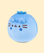 Left quarter view of the blue-colored Pusheen Squisheen. In this angle, Pusheen’s triangle ears can be seen coming off the round plush body slightly. 
