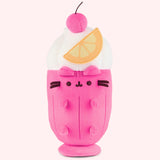 Front view of the Pusheen Fruits Fruit Parfait Plush. Pusheen the Cat takes the form of a delightful dessert served with a whipped topping, hot pink cherry, and orange slice. The whipped topping is white and extends off the glass-shaped body. 