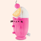 Left quarter view of the Fruit Parfait Plush. The drink-inspired plush has a whipped topping in a swirl pattern topped with a hot pink cherry with a brown stem. 