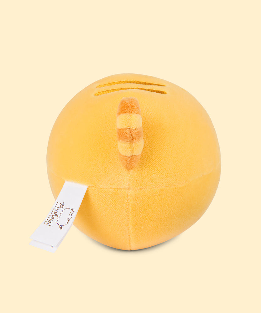 Back view of the Pusheen Fruits Lemon Squisheen Plush. Towards the top back of the yellow squisheen isPusheen’s signature back stripes duo embroidered in dark yellow. Under the stripes is Pusheen’s striped tail in alternating yellow colors. 