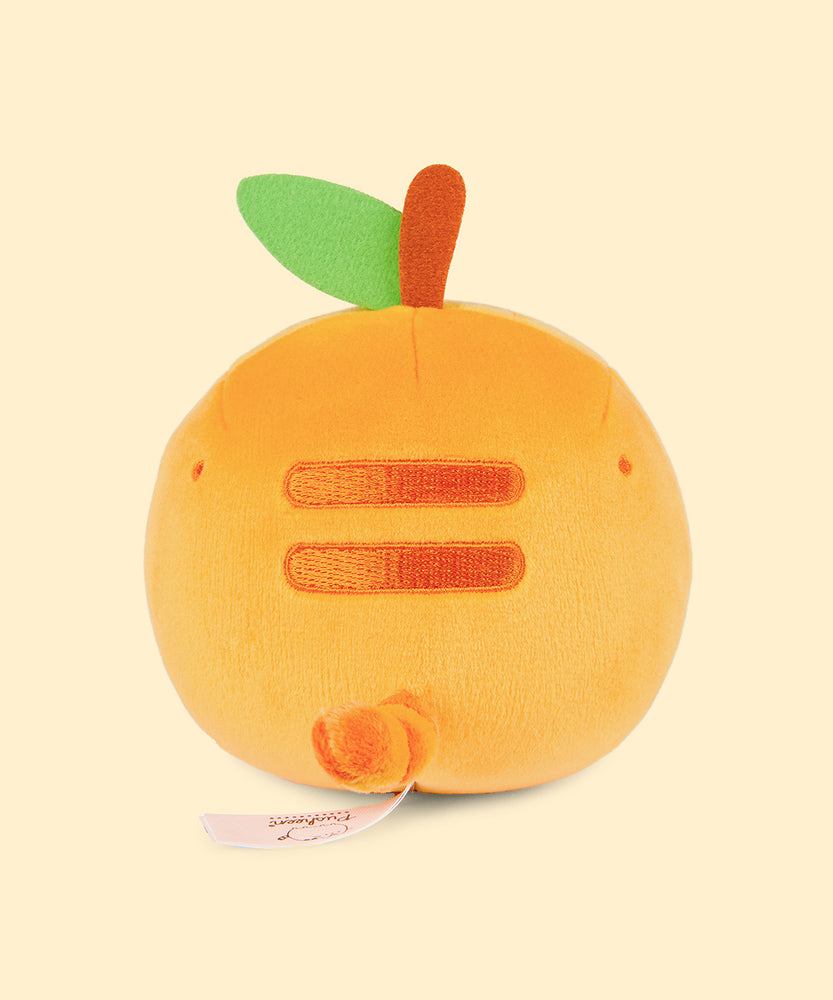Back view of the Pusheen Fruits Orange Squisheen Plush. The back of the orange squisheen has Pusheen’s signature back stripes duo embroidered in dark orange. Under the stripes is Pusheen’s striped tail in alternating orange colors. Coming off the top of the plush is a brown felt stem and green felt leaf. 