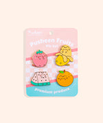 Pusheen Fruits Pin Set on a yellow background. Pusheen the Cat takes the form of a strawberry, banana, watermelon slice, and orange. The features of the pins are outlined in a shiny gold finish.