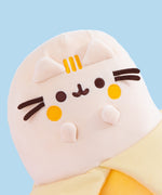 Close-up view of Banana Plush. Pusheen the Cat takes the form of a delicious yellow banana that sits upright. Pusheen's front paws indicate a "gasp" expression.