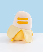 Back view of the Pusheen Banana Plush. Pusheen two back stripes are embroidered in darker yellow. Her tail comes out the bottom portion of the plush and is striped two-toned yellow.