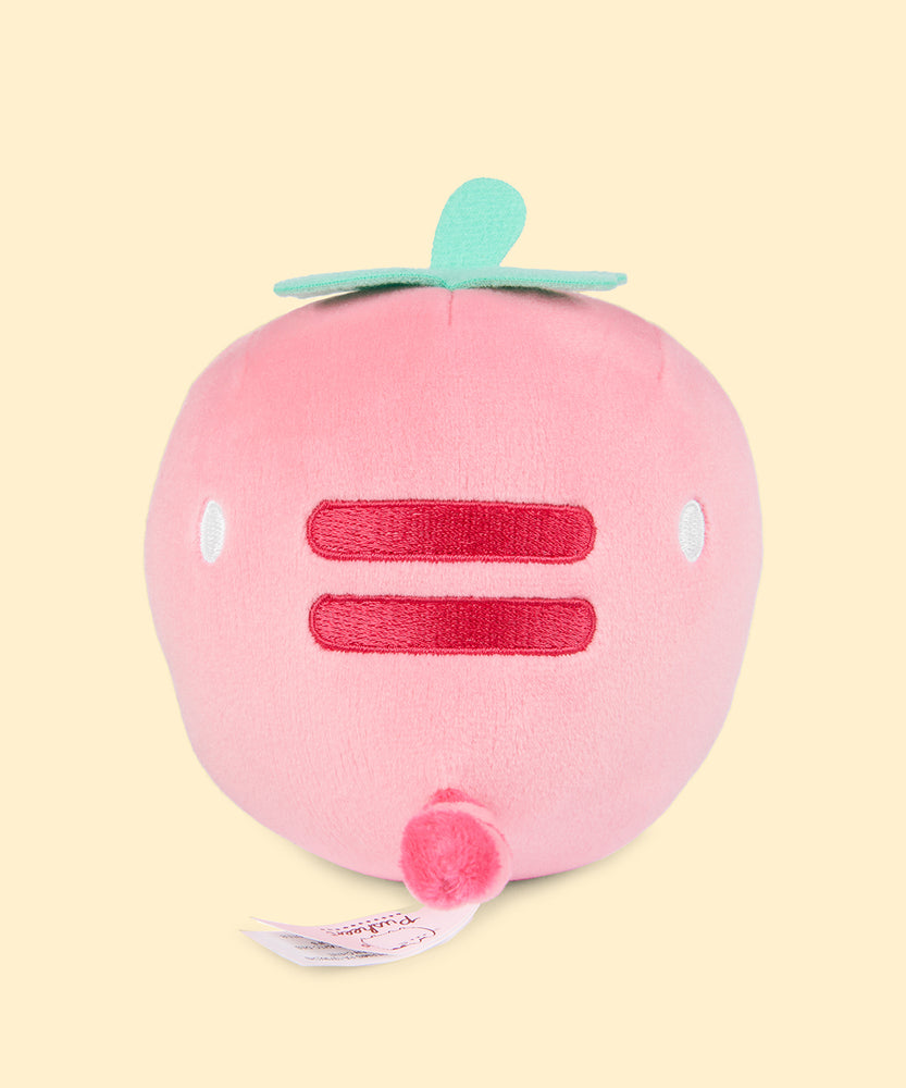 Back view of the Pusheen Fruits Strawberry Squisheen Plush. On the back of the light pink squisheen is Pusheen’s signature back stripes duo embroidered in dark pink. Under the stripes is Pusheen’s striped tail in alternating pink colors. Coming off the top of the plush are green felt leaves and a stem. 