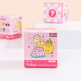 A close-up of the Pusheen Surprise Plush packaging. The front of the packaging features Pusheen as various fruit characters including a peeled yellow banana, yellow pineapple, and pink and green watermelon slice. The packaging says that these Surprise Plush are mini plush. 
