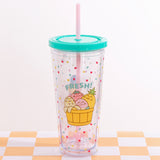 Front view of the Pusheen Fruits Tumbler. The clear beaker has a confetti print all over the clear base. The graphic on the front of the tumbler features Pusheen as a Banana, Peach, Strawberry, and Pineapple tucked inside a basket.