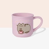 Back view of Pusheen pink mug. The light-pink cup features a grey and brown graphic of Pusheen relaxing with her own hot beverage in a pink mug. The graphic on the back matches the graphic on the front. 