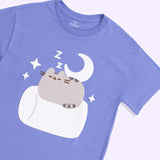 A close-up view of the screen printed graphic on the Pusheen Good Night Unisex Tee. In the graphic, the grey tabby cat is napping on a white marshmallow surrounded by dreamy details including a moon, stars, and ZZ's. 