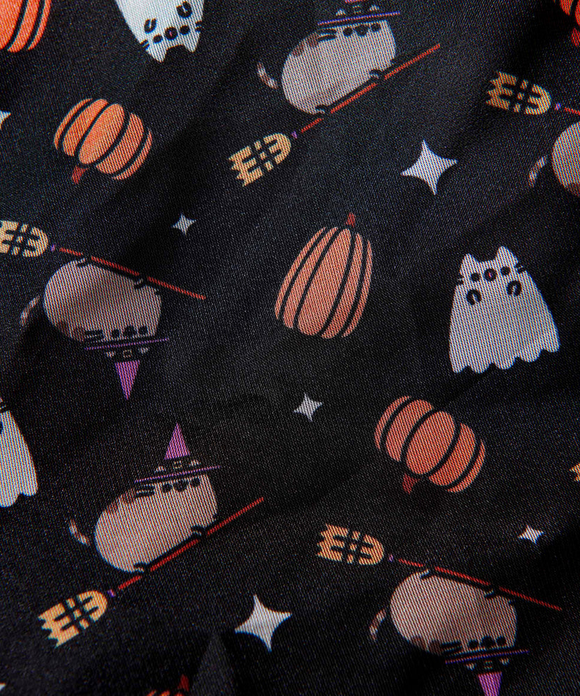 Close-up of Halloween print on polyester scarf. The print features pumpkins, white sparkles, Boosheen startled, and Witch Pusheen riding a brown and yellow broom.  