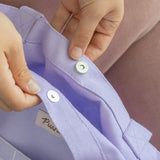 Close-up view of the magnetic button closure on the large purple tote bag.