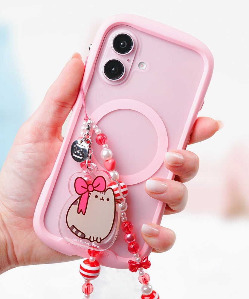 Beaded Phone Charm attached to backing packaging. The red and white paper card has the Pusheen logo on the top corner and says "beaded phone charm" on the front. 