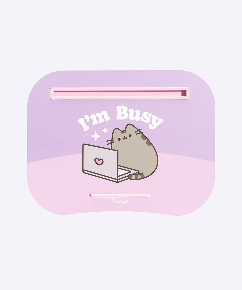 Front view of the Pusheen Laptod Pad. The purple pad has light pink and light purple details and tray inserts. The graphic of Pusheen shows her with a greay laptop.