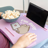 Model using laptop pad while device placed in slot and a snack on the tray.