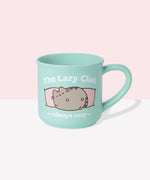 Back view of Pusheen mint green mug. The mint green cup features a grey and brown graphic of Pusheen winking and being lazy. The graphic on the back matches the graphic on the front. 