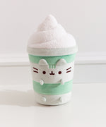 Front view of the Pusheen Matcha Latte Plush. Pusheen the Cat takes the form a layered green drink served with textured, whipped topping.