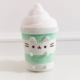 Front view of the Pusheen Matcha Latte Plush. Pusheen the Cat takes the form a layered green drink served with textured, whipped topping.