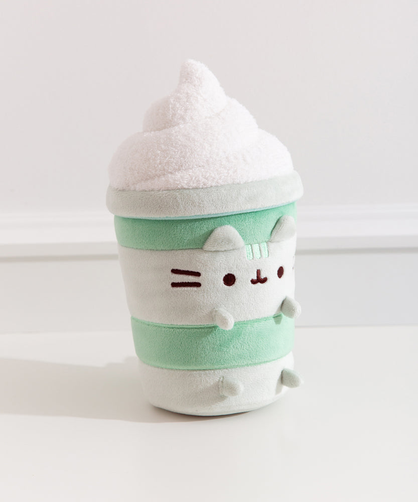 Right quarter view of the medium sized plush.Pusheen's ears and four paws extend off the body of the drink container portion of the plush.