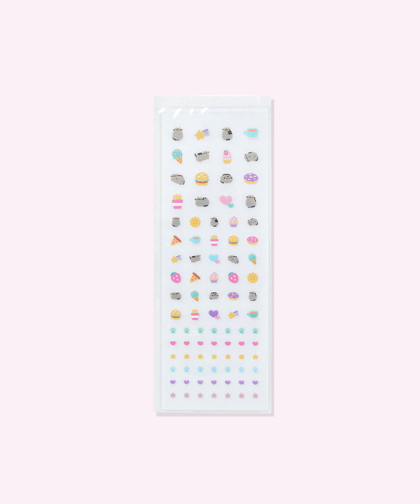 Sticker sheets in the Pusheen Nail Stickers kit. The set includes several variations of a grey Pusheen the Cat as well as paws, hearts, stars, sweets, and savory snacks. 