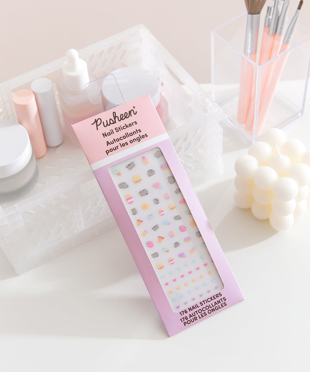 Sweets and savory snacks nail sticker set rests on a desktop. The set includes stickers of Pusheen the cat. 