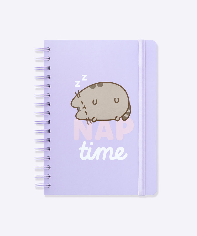 Front view of the Pusheen spiraled notebook. The purple A5 notebook has a graphic of Pusheen the Cat sleeping soundly on the front cover.