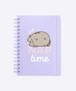 Front view of the Pusheen spiraled notebook. The purple A5 notebook has a graphic of Pusheen the Cat sleeping soundly on the front cover.