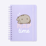 Front view of the Pusheen spiraled notebook. The purple A5 notebook has a graphic of Pusheen the Cat sleeping soundly on the front cover.