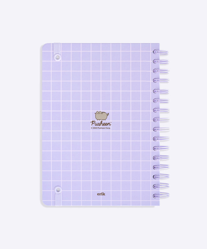 Back cover of the Pusheen notebook. The light purple notebook has a grid pattern. The elastic band to keep the notebook closed is attached on the corners of the back cover.