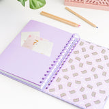 Interior view of the Pusheen notebook. The back cover features a pattern of Pusheen with stars. Before the cover is a pages with a slot to hold loose papers.