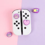 Pusheen Nintendo Switch Thumb Grip Caps on white Nintendo Switch Joy Cons. There are four different grip caps in the set. 