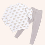 The Pusheen Patterned Loungewear Set lies on a yellow background. The set is shown in its entirety with the sleeves laid flat and the leggings shown at full length.  