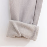 Close-up view of the interior of the leggings. The taupe bottoms have a soft taupe-colored interior lining. 