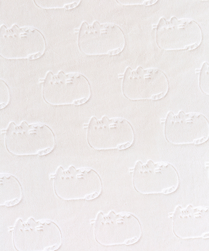 Close-up view of the embossing detail on the Pushee Patterned Sherpa Blanket. The embossed outlines of Pusheen repeats all over one side of the blanket. The polyester blanket is backed with a cream, fuzzy sherpa material. 