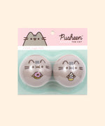 Pusheen Cat Jingle Balls in packaging. The balls are encased in a clear plastic on a backing card. The backing card is two-toned pink and mint-green and states "Pusheen the Cat, 2-Pack Jingle Balls.