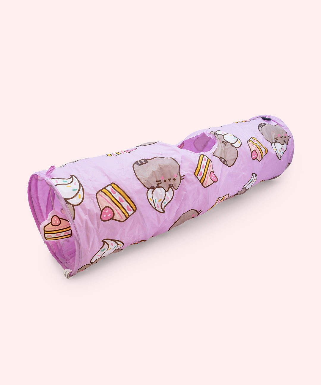 Purple Pusheen Pet Collapsible Tunnel with designs of Pusheen blushing with a whipped cream topping and a slice of strawberry cake.