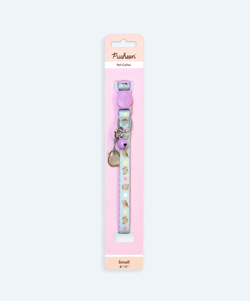 Pusheen Pet Collar attached to its display backing card. Half of the length of the blue collar can be seen with the detachable bell and charm. On the backing card is a size indicator, which is Small and fits 6" to 11" diameter pet necks.