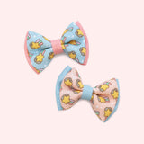 Pusheen Pet Collar Bows that can be added onto pet collars. The two bowties have a graphic of Pusheen with a shooting star surrounded by sparkles. 