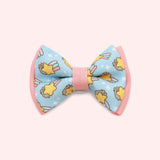 Close-up of the blue bowtie in the Collar Bows 2-pack. The main bowtie background color is blue and has pink piping details. 