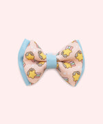 Close-up of the pink bowtie in the Collar Bows 2-pack. The main bowtie background color is pink and has blue piping details. 