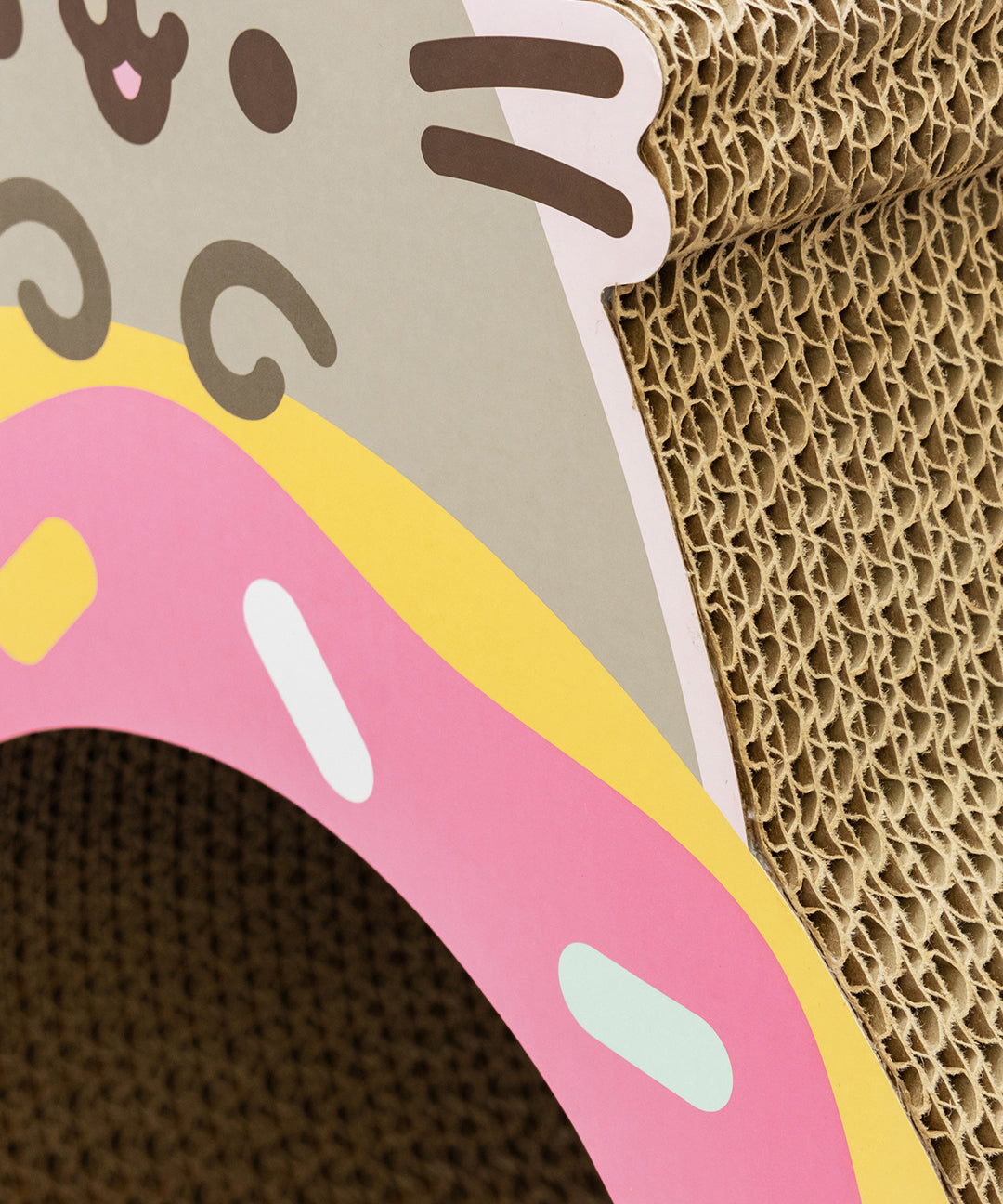 Cardboard Pusheen Pet Donut cat scratcher with donut design and corrugated texture.