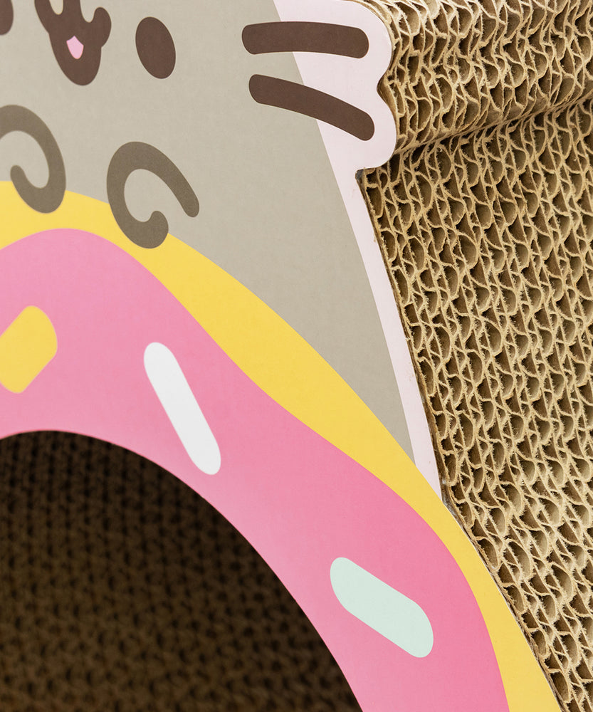 Alternate side view of the Donut Scratcher. The cat scratcher side shows layers of cardboard. 