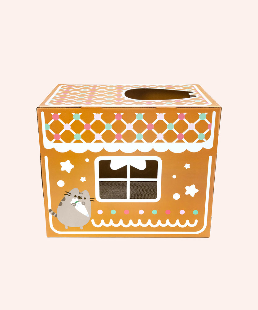 Side view of the Pusheen Cat Scratcher. The gingerbread house has frosting details that resemble a thatched roof with gumdrop details. 