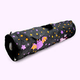 Full view of the Pusheen Pet Halloween Bat Collapsible Tunnel. The long tunnel has a rounded opening on both ends and a surprise circle opening in the top middle of the tube. One opening has a dangling plush of a crescent moon.